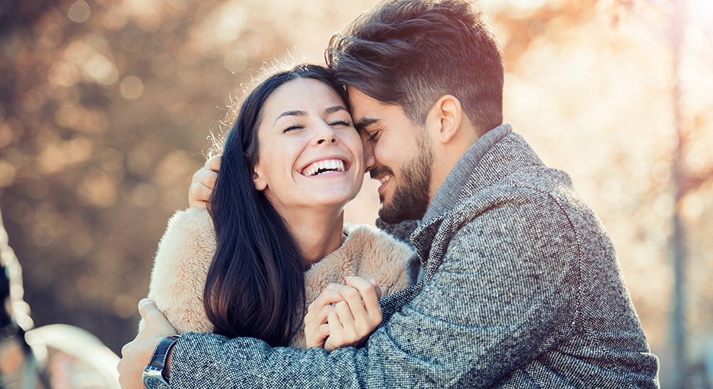 Couple smiling at each other and celebrating