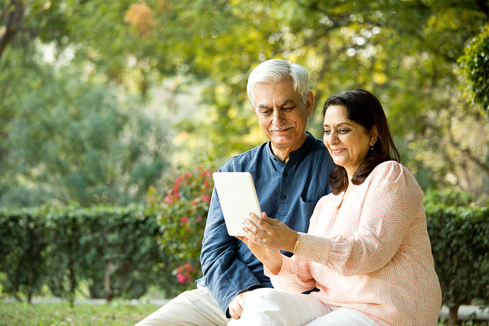 Couple using a tablet to send their ID information to Lottoland and verify their player accounts