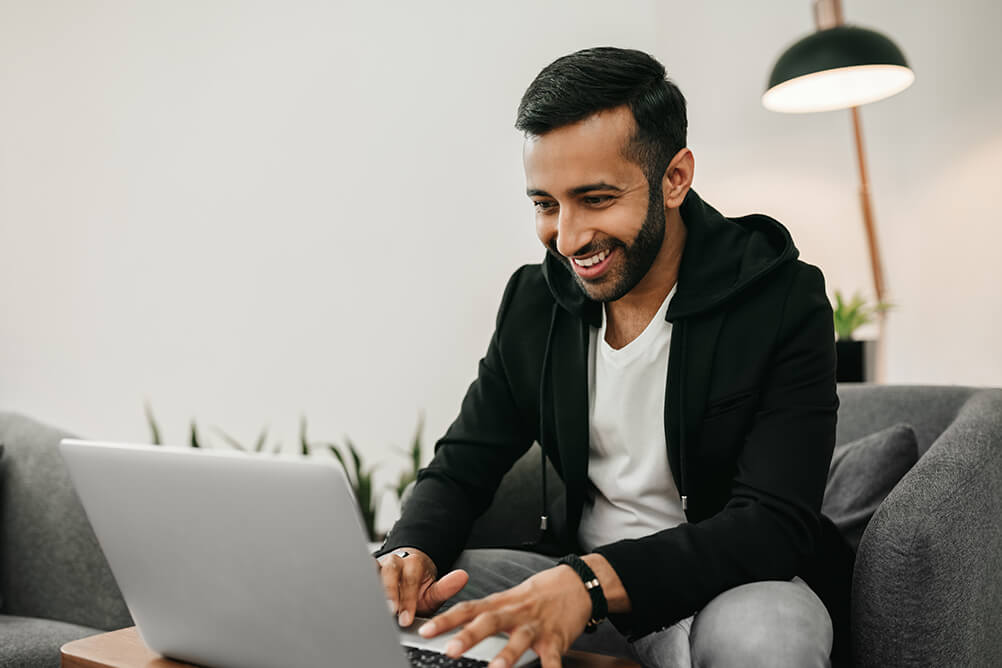 Smiling man checking if lottery winnings are taxed in India