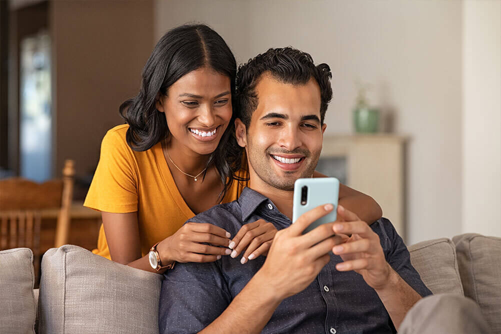 Happy couple checking payment methods on Lottoland Asia