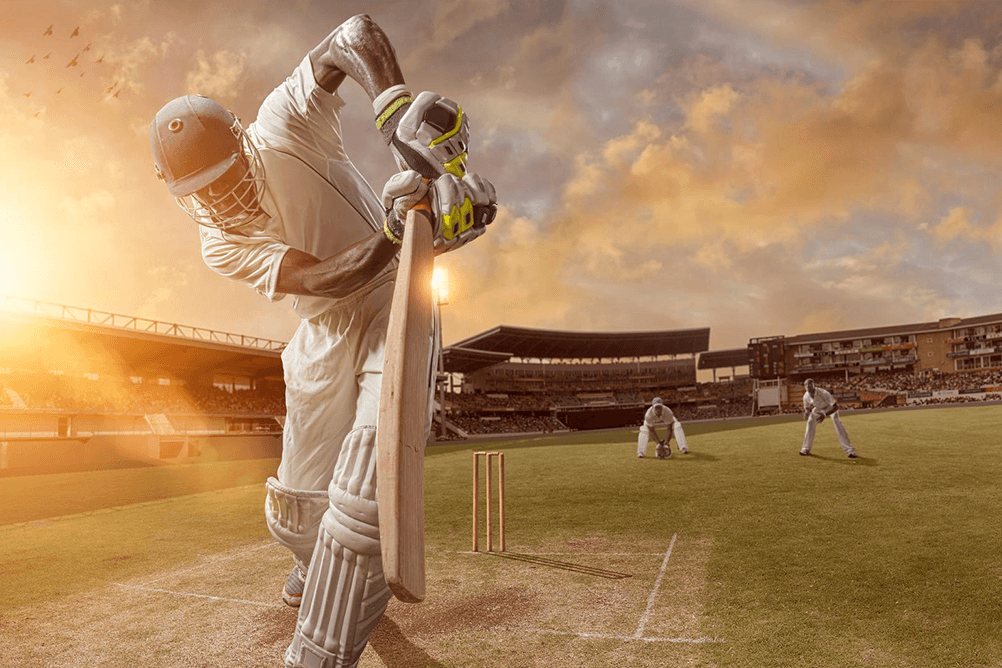 Cricket batsman hitting the ball during a cricket match with fans betting on cricket