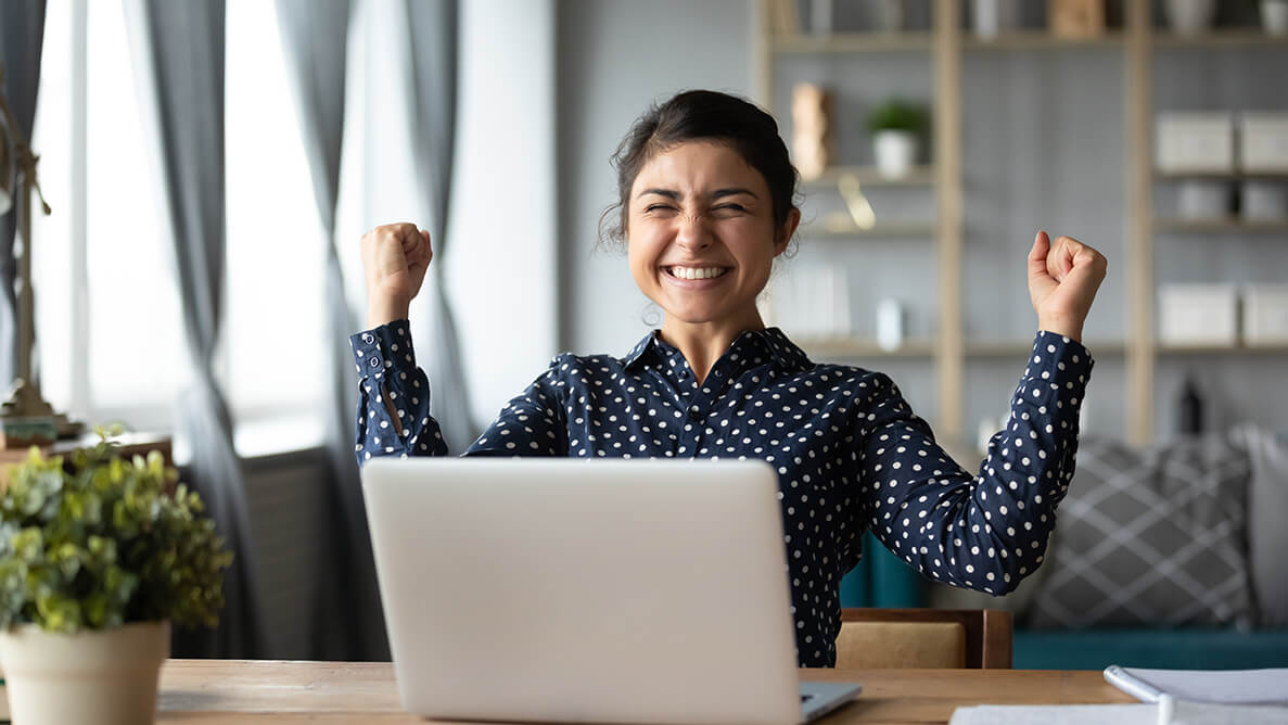 Indian woman celebrating winning the lottery after reading an article about how to win the lottery