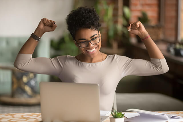 Happy woman checking the probability of winning the lottery on her computer