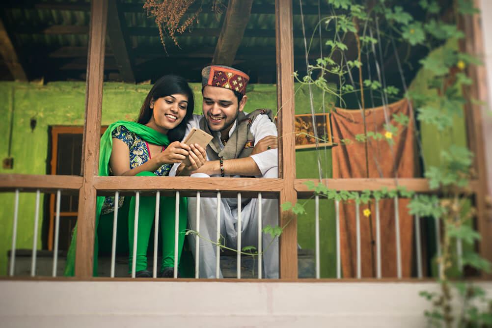 Happy couple looking at lottery prices on mobile