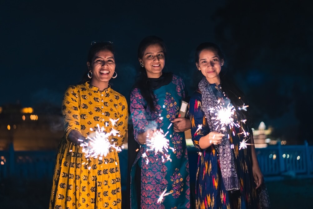 Women holding sparklers